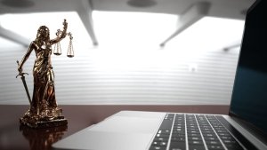 Lady Justice Statue With A Notebook In The Office. 3d Illustration.